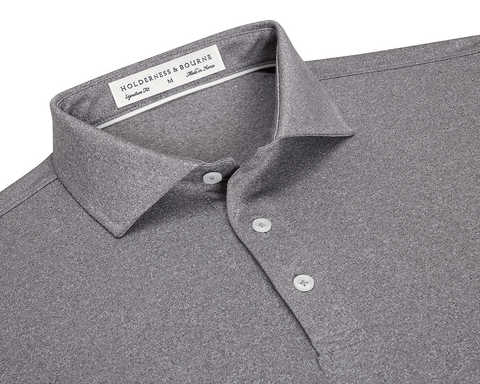 The Anderson Shirt: Heathered Gray features a classic collar, three-button placket, and jersey knit fabric for stretch and moisture-wicking comfort.