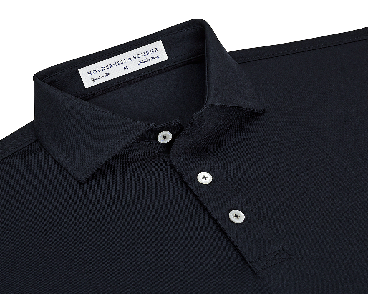 The Anderson Shirt: Black, featuring a dark-navy polo with a classic point collar, three white buttons, and a woven label, offering stretch and moisture-wicking comfort.