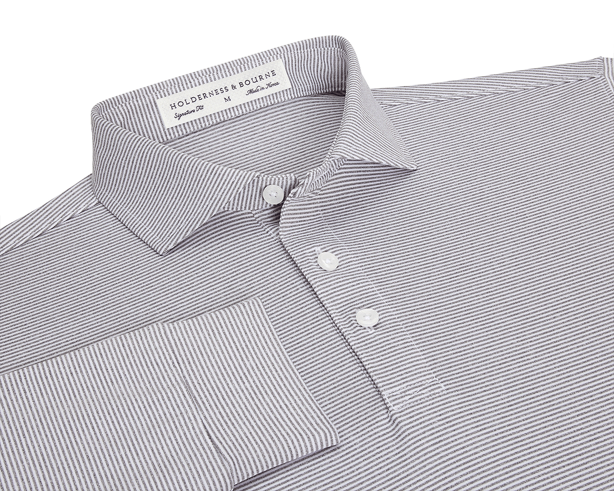 The Burke Shirt: Gray & White, featuring narrow stripes, a structured spread collar, three-button placket, cuffed sleeve, and Holderness & Bourne label, offers UPF 50+ protection.