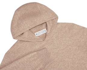 The Logan Hoodie Sweater: Heathered Dune, a soft knit with ribbed hood and cuffs, crafted from Merino wool and cashmere for warmth and breathability.