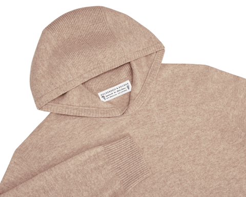 The Logan Hoodie Sweater: Heathered Dune, a soft knit with ribbed hood and cuffs, crafted from Merino wool and cashmere for warmth and breathability.