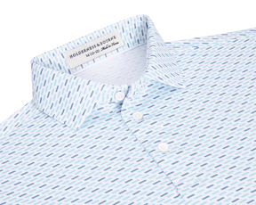 The James Boys Shirt: Harbor & Maidstone Blue features a white collared design with blue dash motifs, offering breathable, moisture-wicking performance and UPF 50+ sun protection.