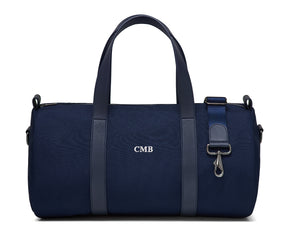 The Marston Banker Bag: Navy Ballistic - White Embroidery, featuring canvas fabric, leather trim, monogram CMB, top handles, detachable strap, and gunmetal hardware.
