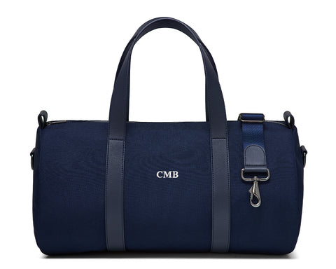 The Marston Banker Bag: Navy Ballistic - White Embroidery, featuring canvas fabric, leather trim, monogram CMB, top handles, detachable strap, and gunmetal hardware.