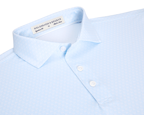The Griffin Shirt: Vista Blue, featuring a light-blue geometric print, structured collar, and three-button placket, designed for comfort and versatility with performance fabric.