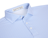 The Fulton Shirt: Belmont & Horizon Blue, featuring a light blue geometric print, semi-spread collar, and pearly buttons, perfect for warm-weather comfort.
