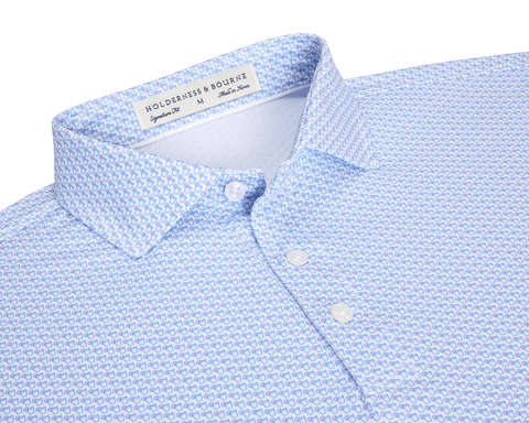 The Fulton Shirt: Belmont & Horizon Blue, featuring a light blue geometric print, semi-spread collar, and pearly buttons, perfect for warm-weather comfort.