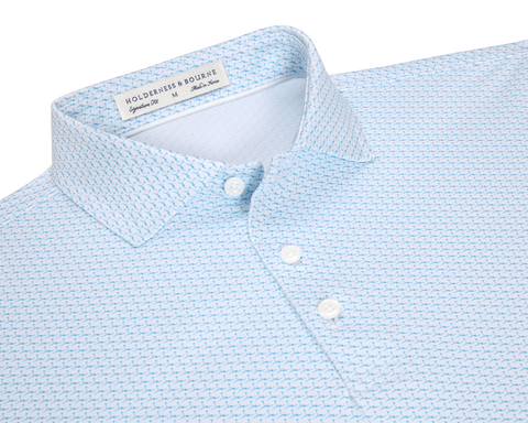 The Atwood Shirt: Harbor features a geometric motif, classic collar, three-button placket, and brand label, offering style and performance with moisture-wicking and sun protection.