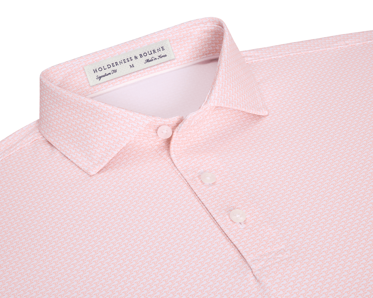 The Hanover Shirt: Nectarine features a geometric print, three-button placket, and a structured spread collar, offering performance with moisture wicking and UPF 50+ protection.