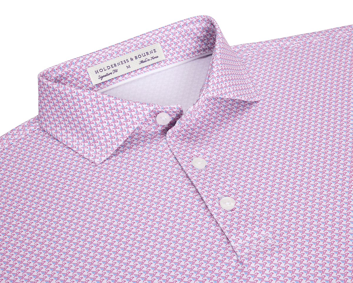 The Justice Shirt: Horizon Blue & Cabernet, featuring a light pink polo with a blue-and-white chevron pattern, three-button placket, and Holderness & Bourne label.