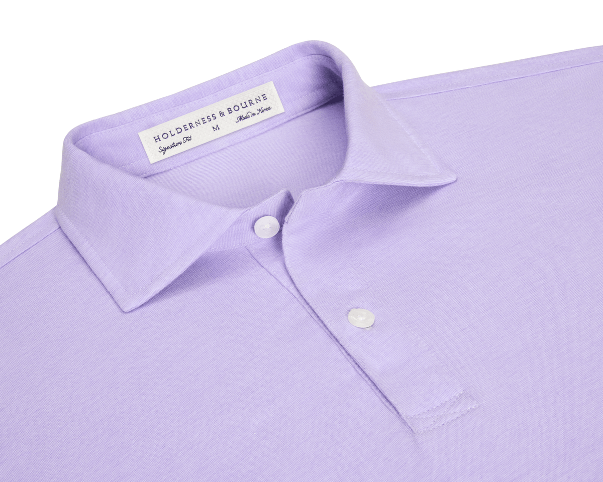 The Hatcher Shirt: Tudor & White, a lavender men’s polo with a two-button placket, spread collar, and Holderness & Bourne tag visible.