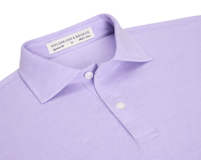 The Hatcher Shirt: Tudor & White, a lavender men’s polo with a two-button placket, spread collar, and Holderness & Bourne tag visible.