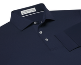 The Farrell Shirt: Navy, long-sleeve polo with a button placket, spread collar, and moisture-wicking jersey knit. Features include a label reading Holderness & Bourne, Signature Fit.