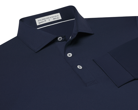 The Farrell Shirt: Navy, long-sleeve polo with a button placket, spread collar, and moisture-wicking jersey knit. Features include a label reading Holderness & Bourne, Signature Fit.