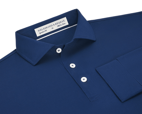 The Abbott Shirt: Navy, featuring a deep-blue long-sleeve design with a structured collar, three white buttons, a chest pocket, and contrast collar band piping.