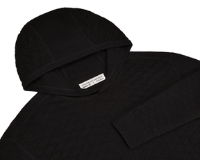 The Wallace Hoodie Sweater: Black features a quilted knit, ribbed hood and cuffs, and a label reading “Holderness & Bourne, Signature Fit, M.”