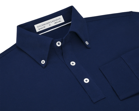 The Burton Shirt: Navy, featuring a button-down collar and white buttons, offers a refined look with its cotton-elastane pique knit and stretch ribbed cuffs.