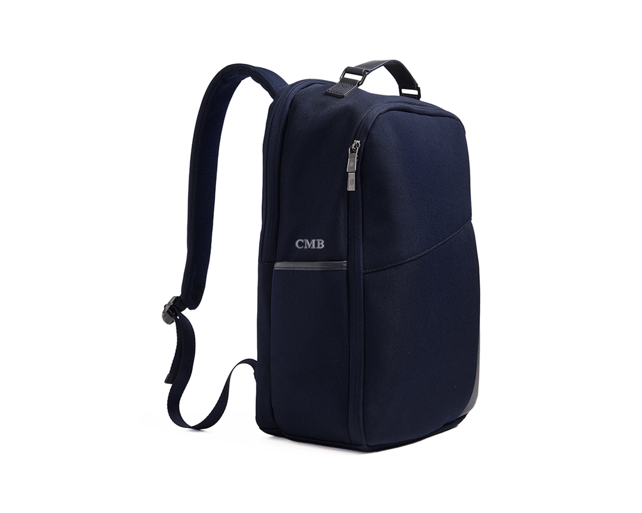 The Broughton Backpack: Navy Ballistic - Slate Blue Embroidery, featuring a sleek design with zippered compartments, padded straps, and personalized initials CMB on the front.