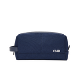 The Littler Dopp Kit: Navy Ballistic - White Embroidery, featuring a rectangular design with a top zipper, side handle, and personalized initials CMB.