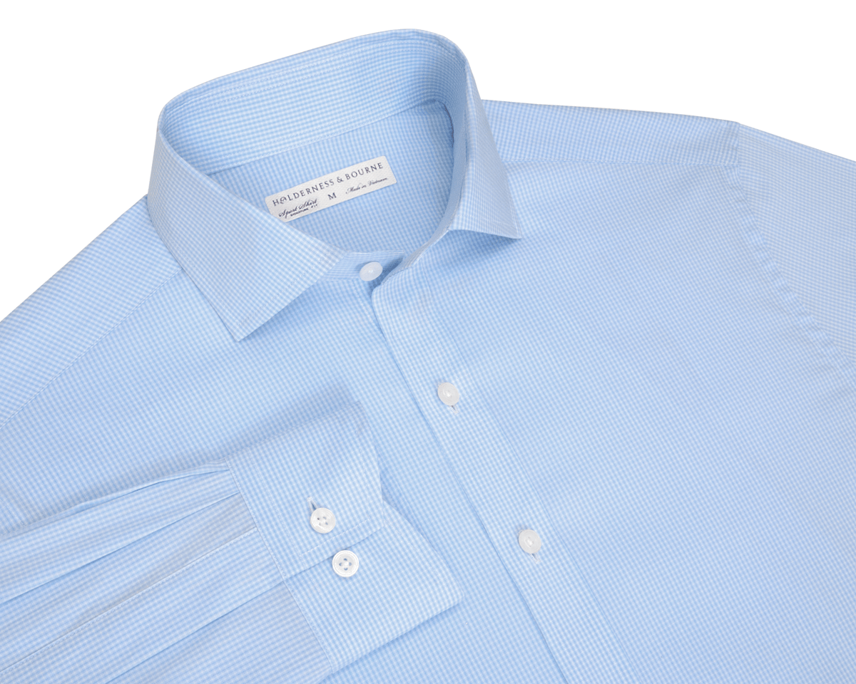 The McAllister Shirt: Vista Blue, featuring a pale blue micro-check fabric, long sleeves, button-front, point collar, and two-button cuffs, offers polished style and comfort.