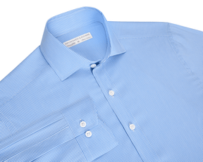 The McAllister Shirt: Horizon Blue, features a light blue micro-check pattern, spread collar, button-front, and white buttons, offering breathable, wrinkle-resistant comfort.