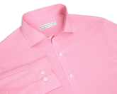 The McAllister Shirt: Belmont, a light pink micro-gingham men's dress shirt, features a structured spread collar, white buttons, and a visible cuff.