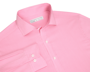 The McAllister Shirt: Belmont, a light pink micro-gingham men's dress shirt, features a structured spread collar, white buttons, and a visible cuff.