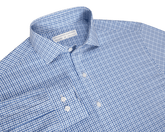 The Wright Shirt: Vista Blue, a men’s long-sleeve dress shirt with a blue windowpane pattern, spread collar, and white buttons, offers comfort and wrinkle resistance.