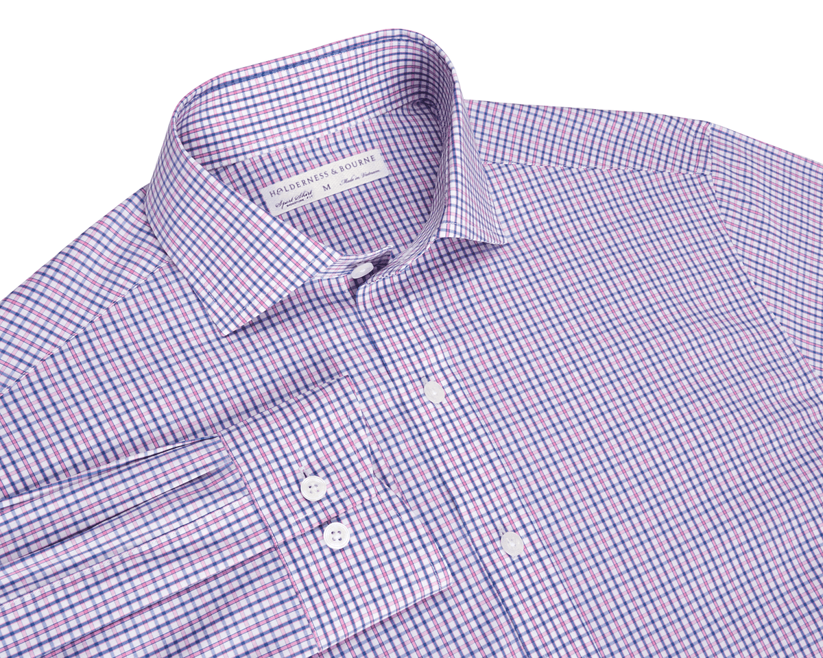 The Wright Shirt: Belmont, a neatly folded, long-sleeve button-up with purple-and-blue gingham pattern, features a structured spread collar and performance cotton-blend fabric.