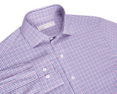 The Wright Shirt: Belmont, a neatly folded, long-sleeve button-up with purple-and-blue gingham pattern, features a structured spread collar and performance cotton-blend fabric.