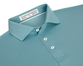 The Anderson Shirt: Harbor, featuring a structured spread collar, three-button placket, and jersey knit fabric for stretch and moisture wicking, laid flat.