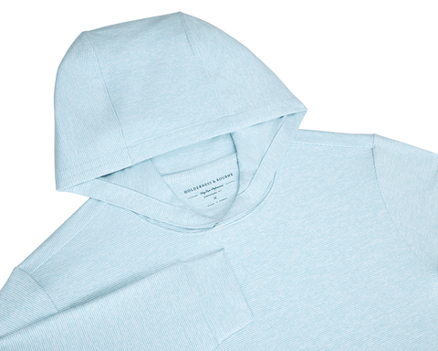 The Hamilton Hoodie: Heathered Harbor & White, light-blue with fine white pin-stripes, features a hood, sleeve, and Holderness & Bourne tag, offering comfort and UPF 50+ protection.