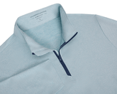 The Bell Quarter-Zip: Heathered Harbor features a teal-toned, textured knit with a navy zipper. It's lightweight, breathable, and designed with a modern drop-tail silhouette.