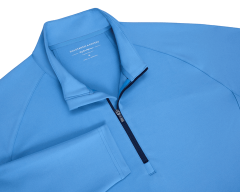 The Rodgers Quarter-Zip: Horizon Blue pullover with a mock-neck style and contrasting zipper, ideal for golf outings, offering stretch, warmth, and UPF 50+ protection.