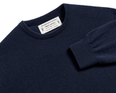 The Buckley Crewneck Sweater: Heathered Dark Navy, crafted from 100% Scottish cashmere, features a classic crewneck and durable doubled cuff design.