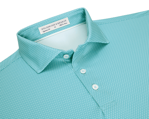 The Hicks Shirt: Harbor, a men’s polo with a white dash pattern, classic collar, three-button placket, and performance jersey for comfort and UV protection.