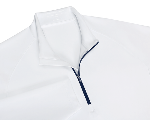 The Rodgers Quarter-Zip: White, featuring a navy-blue zipper, stand-up collar, and low-profile side pockets, ideal for golf with UPF 50+ protection.
