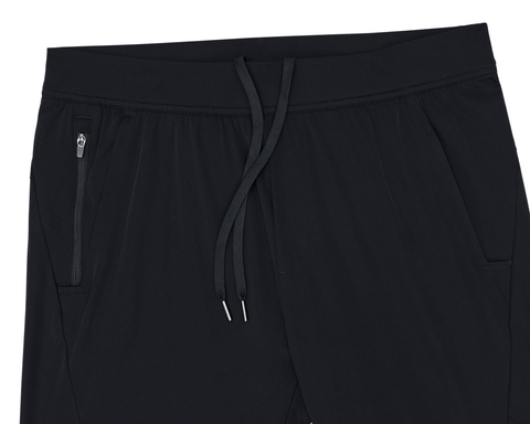 The Saunders Short: Black athletic joggers featuring an elastic waistband with drawstring, zippered pocket, and smooth lightweight fabric for optimal performance.