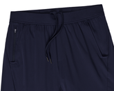 The Saunders Short: Navy athletic pants featuring an elastic drawstring waistband, dual side hand-warmer pockets, and a zip pocket for secure storage.