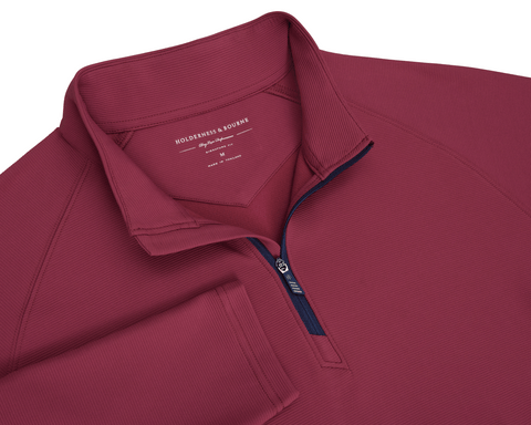 The Stuart Quarter-Zip: Cabernet features a ribbed knit texture, stand-up collar, and navy zipper, showcasing a refined, lightweight design by Holderness & Bourne.