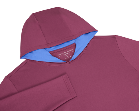 The Jackson Hoodie: Cabernet, flat-lay view, showcasing its streamlined design with a soft performance fabric, burgundy exterior, and contrasting light blue hood lining.