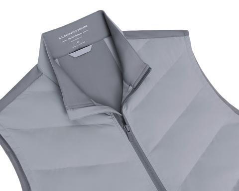 The Benton Vest: Gray features a quilted puffer design with a stand-up collar, full zipper, and visible Holderness & Bourne branding inside the collar.