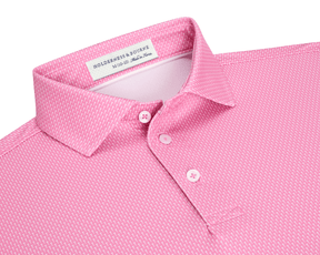 The Hicks Boys Shirt: Belmont, a pink polo with white geometric pattern, features a three-button placket, structured collar, and Holderness & Bourne label.