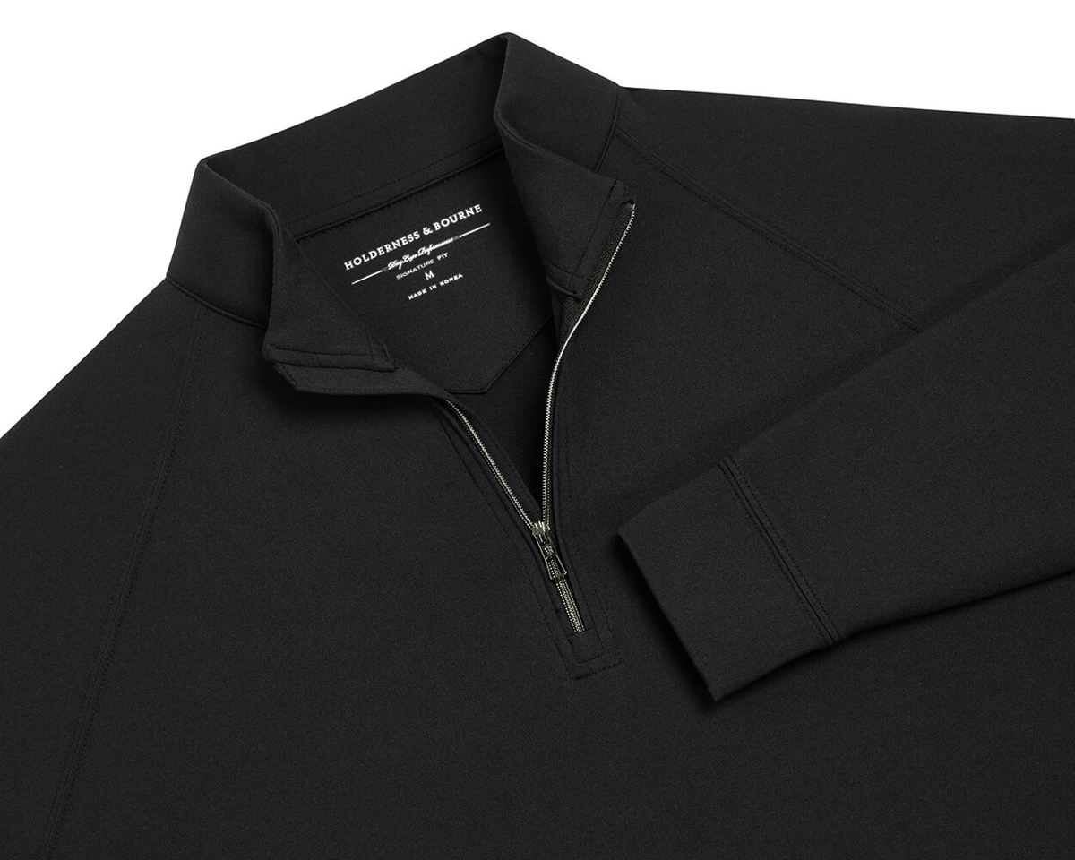 The Westland Quarter-Zip: Black, features a black long-sleeve design with a stand-up collar and quarter-zip, showcasing Holderness & Bourne's signature fit label.