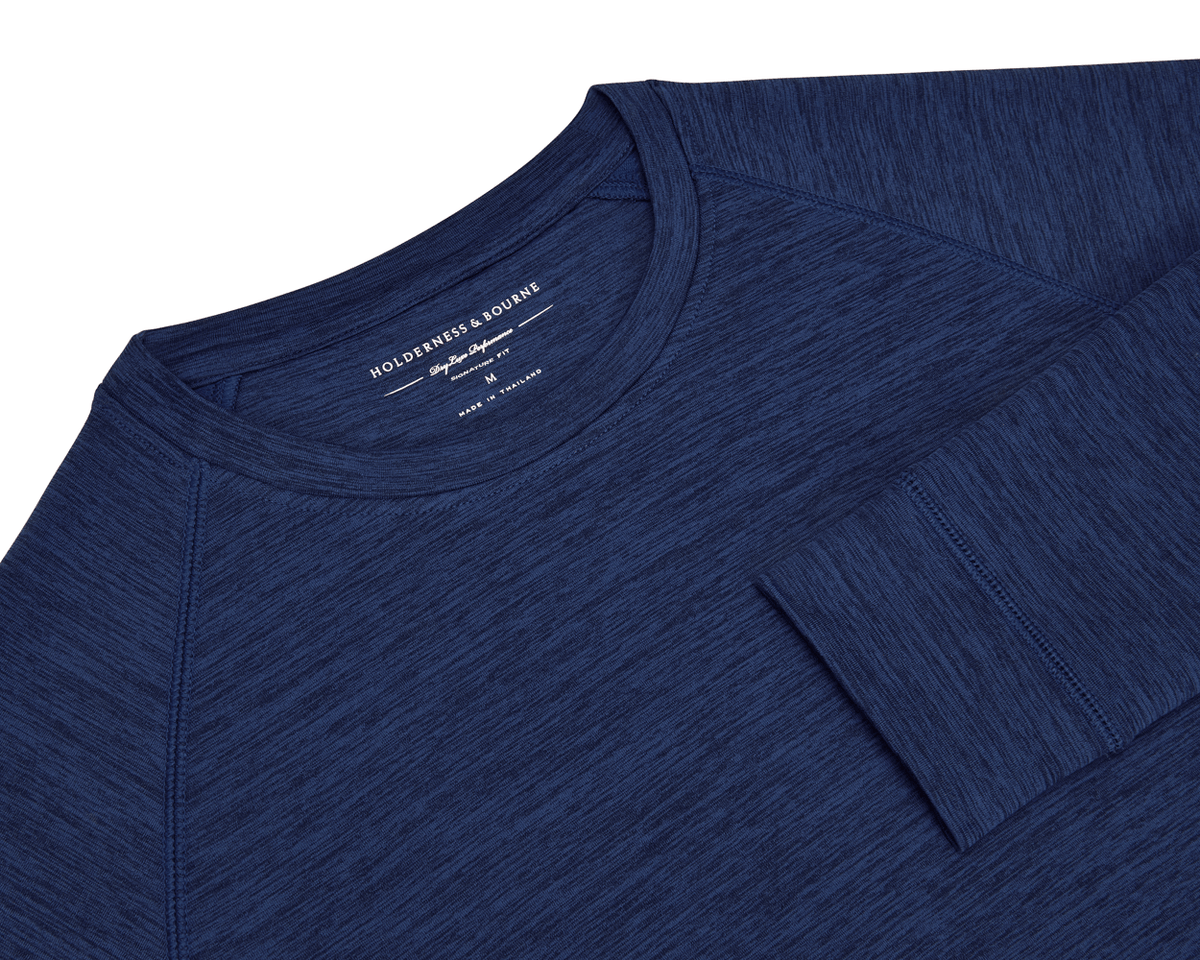 The Laidlay Crewneck: Heathered Navy, a long-sleeve shirt, features a heathered texture and signature fit, offering softness and stretch.