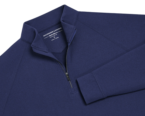 The Westland Quarter-Zip: Navy, features a dark-blue, long-sleeve design with gunmetal chrome trim, offering moisture-wicking performance and a soft, peached synthetic blend.