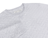 The Ward Crewneck Sweater: Heathered Gray features a textured knit pattern, ribbed details, V-stitch accent, and a Holderness & Bourne label inside the collar.