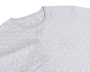 The Ward Crewneck Sweater: Heathered Gray features a textured knit pattern, ribbed details, V-stitch accent, and a Holderness & Bourne label inside the collar.