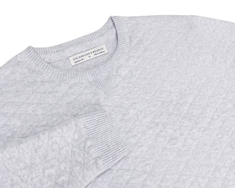 The Ward Crewneck Sweater: Heathered Gray features a textured knit pattern, ribbed details, V-stitch accent, and a Holderness & Bourne label inside the collar.