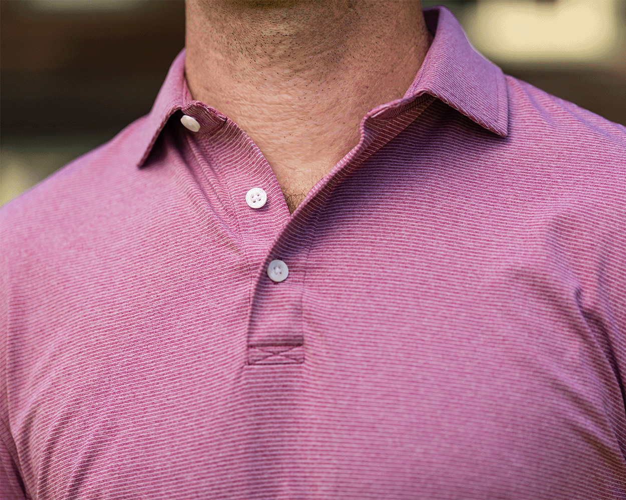 Lifestyle close-up of a model wearing The Holland Shirt: Heathered Napa outdoors, showing the spread collar, buttoned placket, and fine heathered stripes.